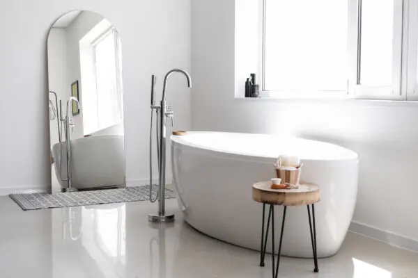 Interior of light bathroom with big mirror